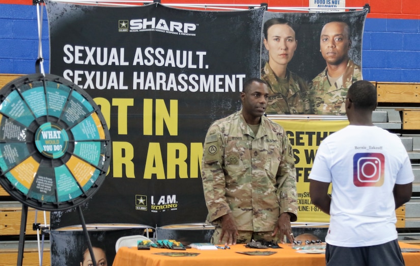 Master Sgt. Arthur Bynes, the Sexual Harassment/Assault Response and Prevention coordinator with the 1st Theater Sustainment Command-Operational Command Post, talks to servicemembers during a health fair hosted by the 452nd Combat Support Hospital, here, Dec. 2.