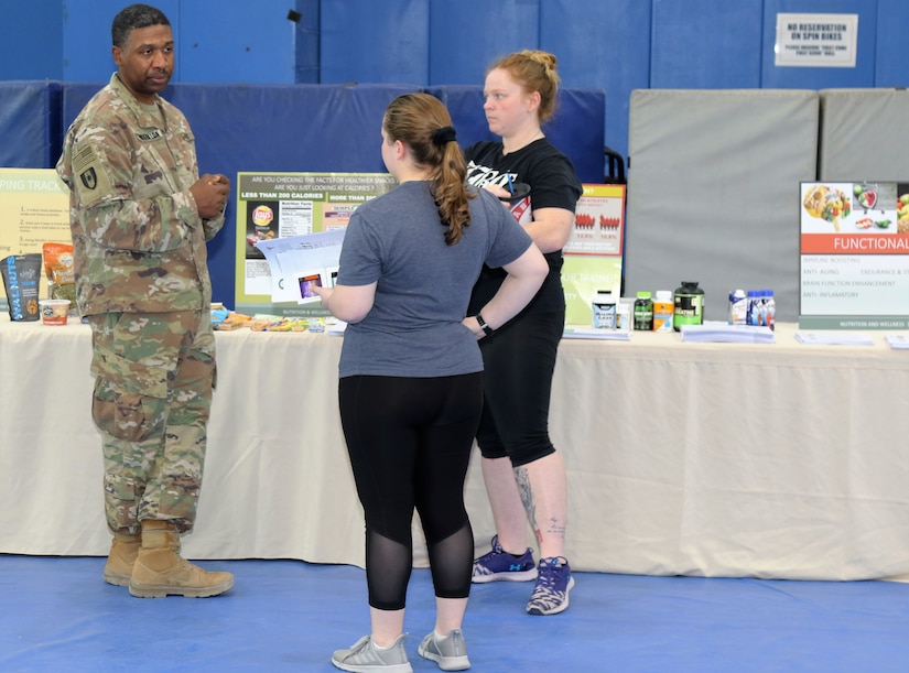 Maj. Justin Washington, a Registered Dietician with the 452nd Combat Support Hospital based out of Fort Snelling, Minn., talks to servicemembers during the health fair, Dec. 2, here.