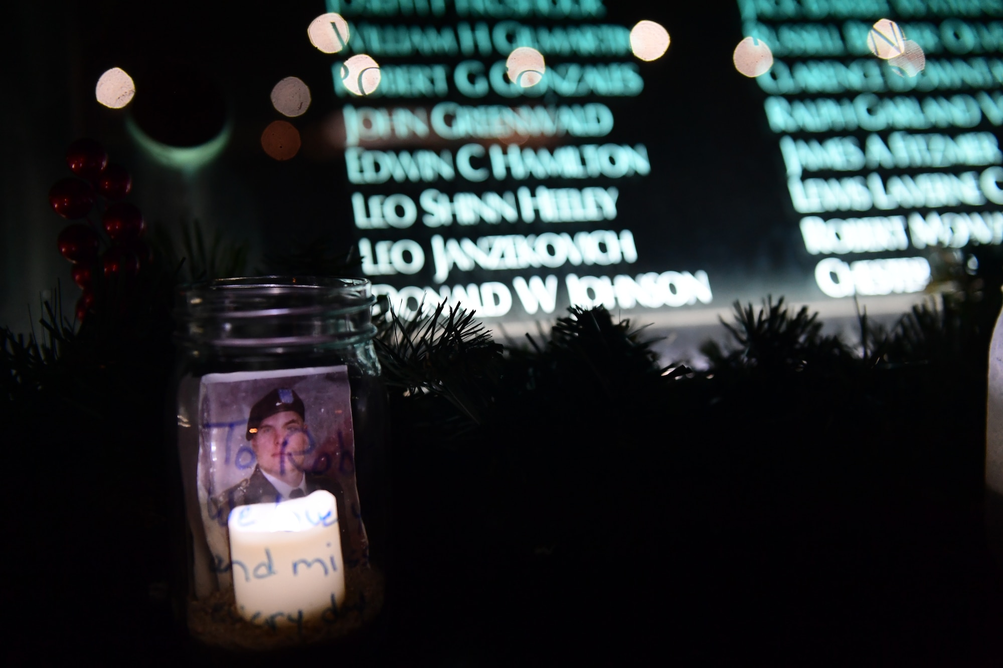 A luminary honoring a fallen service member rests in front of the Colorado Freedom Memorial wall in Aurora, Colorado, Nov. 29, 2018.