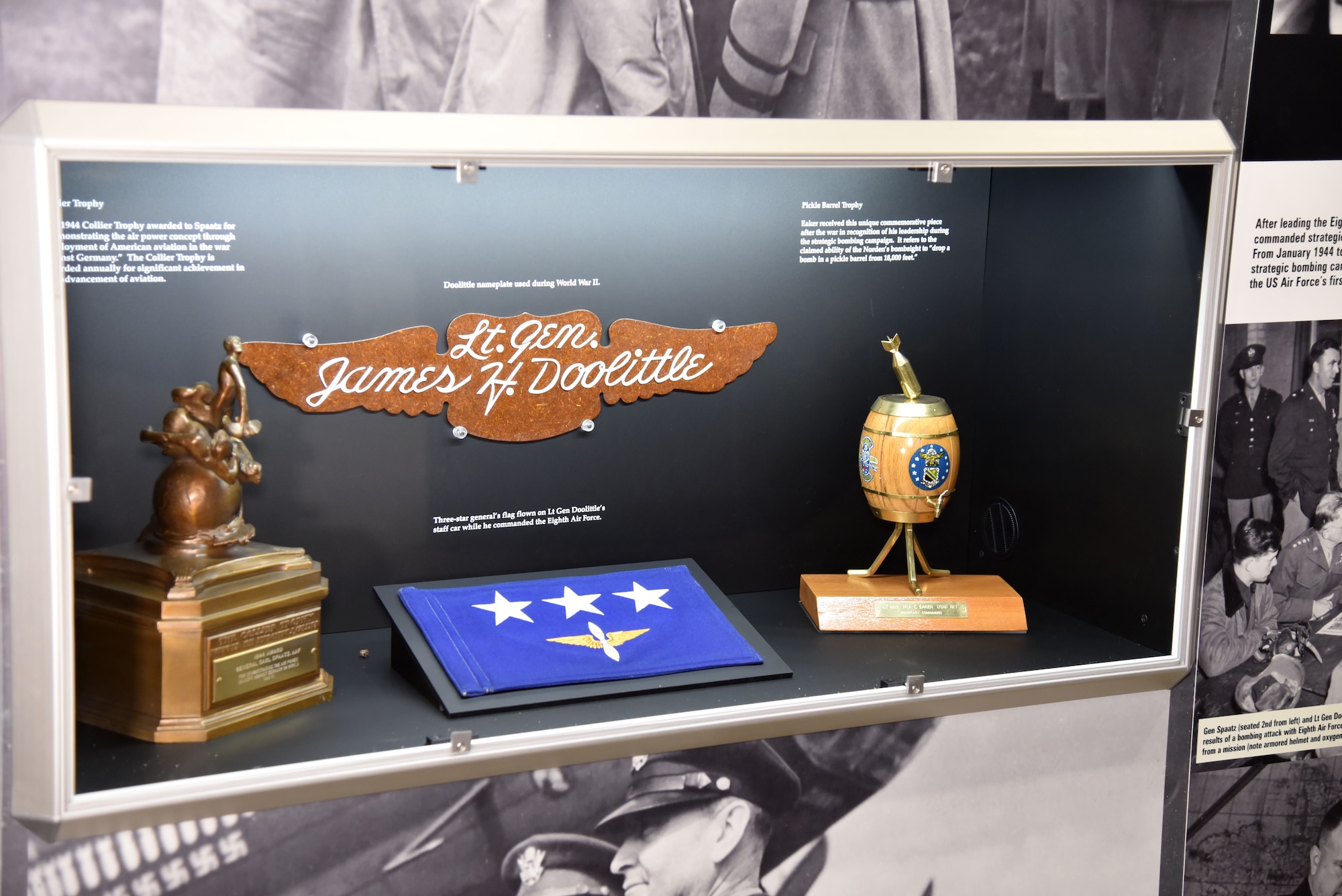 WWII Bombing Campaign Leaders Exhibit case which includes the Pickle Barrel Trophy, Lt. Gen. Doolittle's 3-star flag and name-pate, and the 1944 Collier Trophy on display at the National Museum of the U.S. Air Force. (U.S. Air Force photo)
