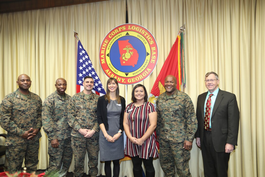 Two members of the Marine Corps Logistics Base Albany family were recognized Thursday with certificates for completing 100 hours of volunteer service with the local Navy-Marine Corps Relief Society.