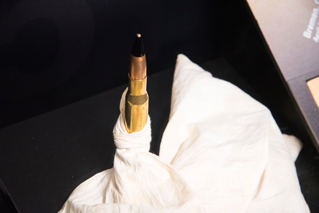 A 50-cal bullet tied to a handkerchief dropped by elated pilot Capt Lawrence Dwyer, Eighth Air Force, while "buzzing" his airfield at Bassingbourn, England, on May 14, 1943.  He had just completed his 25th and last mission over enemy territory, and he was one of the first pilots in the group to do so.