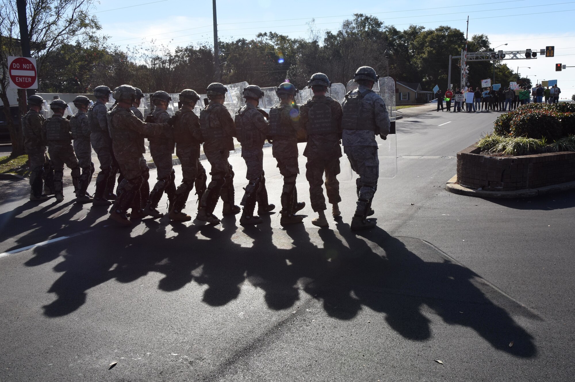 Members of the 81st Security Forces Squadron form a riot control team as they approach protestors during the 81st SFS protest drill at Keesler Air Force Base, Mississippi, Dec. 12, 2018. The scenario included peaceful protestors expressing their first amendment right that further escalated to a riot when they felt they weren't being heard. The drill, which was a joint effort with the Biloxi Police Department, was conducted to control or prohibit demonstrations and protests. (U.S. Air Force photo by Kemberly Groue)