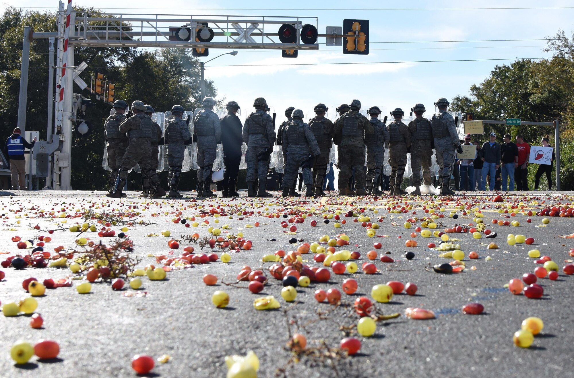 Members of the 81st Security Forces Squadron's riot control team drive protestors off of federal property during the 81st SFS protest drill at Keesler Air Force Base, Mississippi, Dec. 12, 2018. The scenario included peaceful protestors expressing their first amendment right that further escalated to a riot when they felt they weren't being heard. The drill, which was a joint effort with the Biloxi Police Department, was conducted to control or prohibit demonstrations and protests. (U.S. Air Force photo by Kemberly Groue)