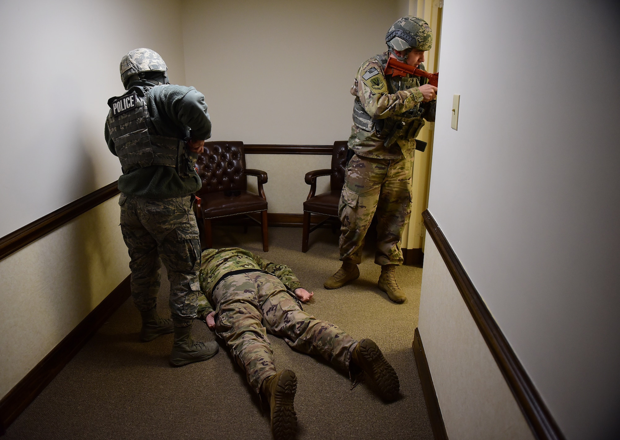 Airman 1st Class Nelly Lewis, 4th Security Forces Squadron patrolman (left), and Staff Sgt. Zackory Lollar, 4th SFS desk sergeant (right), prepare to arrest a simulated active shooter during a planned exercise Dec. 12, 2018, at Seymour Johnson Air Force Base, North Carolina. The 4th Fighter Wing utilizes realistic scenarios such as this one, to help keep Airmen and civilian government employees in a warrior mindset. (U.S. Air Force photo by Senior Airman Kenneth Boyton)