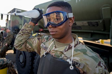 Army Sgt. Leroy Faulkner, a fuel supply specialist from Ft. Lee, Va., mixes fuel with water in order to test the fuel’s content using a refractometer during a during a technical demonstration of the Expeditionary Mobile Fuel Additization Capability at the Charleston Defense Fuel Supply Point Dec. 6, 2018.