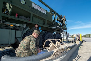 Marine Maj. Kelvin Chew, Marine Corps Expeditionary Office technology and experimentation officer, monitors the amount of fuel pumped through the expeditionary Mobile Fuel Additization Capability at the Charleston Defense Fuel Supply Point Dec. 6, 2018.