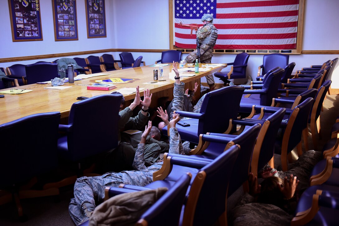Airmen obey the orders of a patrolman during a planned active shooter exercise Dec. 12, 2018, at Seymour Johnson Air Force Base, North Carolina. The 4th Fighter Wing, Plans and Programs, and the Inspector General design exercises to prepare and test the readiness of Airmen at Seymour Johnson AFB. (U.S. Air Force photo by Senior Airman Kenneth Boyton)