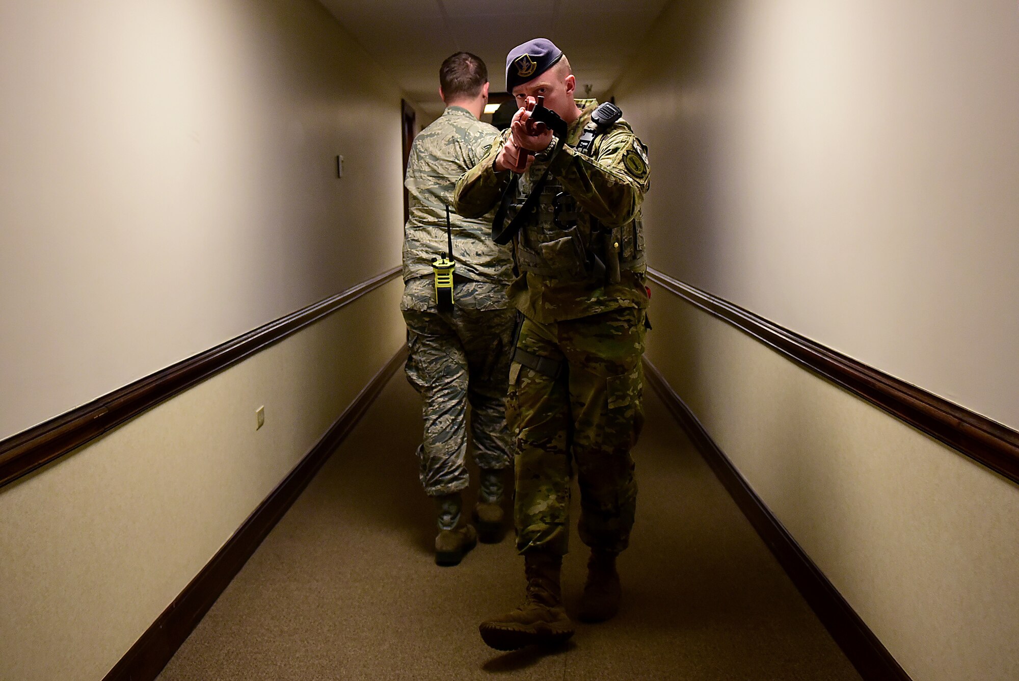 Senior Airman Daniel Johnson, 4th Security Forces Squadron military working dog handler, provides rear security for two responders from the 4th Civil Engineer Squadron during a planned active shooter exercise Dec. 12, 2018, at Seymour Johnson Air Force Base, North Carolina. The 4th Fighter Wing utilizes realistic scenarios such as this one, to help keep Airmen and civilian government employees in a warrior mindset. (U.S. Air Force photo by Senior Airman Kenneth Boyton)