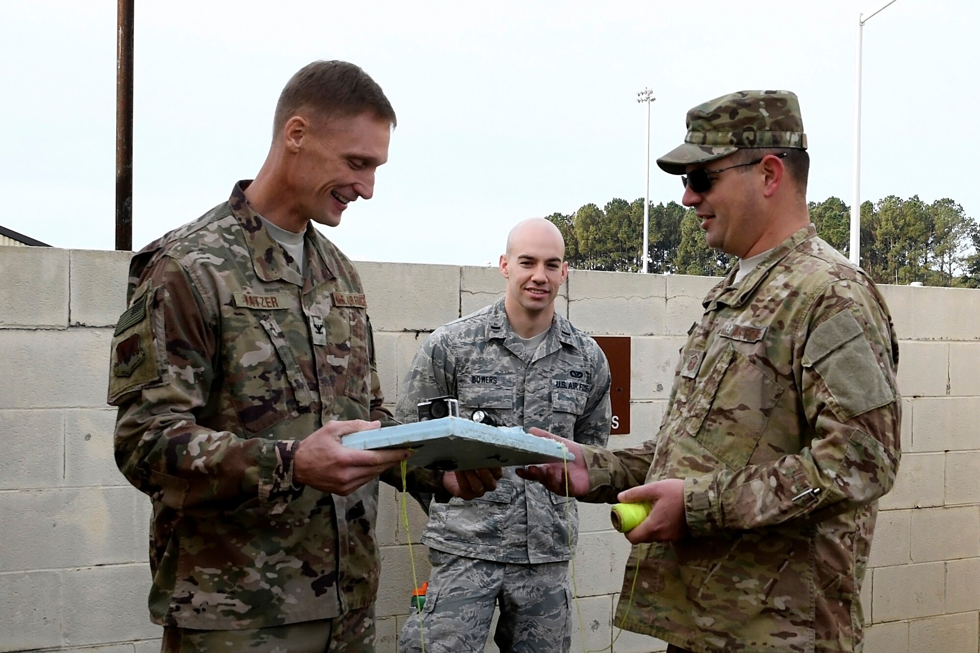 Col. Dee Jay Katzer, Air Combat Command chief of civil engineer division (left), examines a homemade floating exploratory device Dec. 12, 2018, at Seymour Johnson Air Force Base, North Carolina.