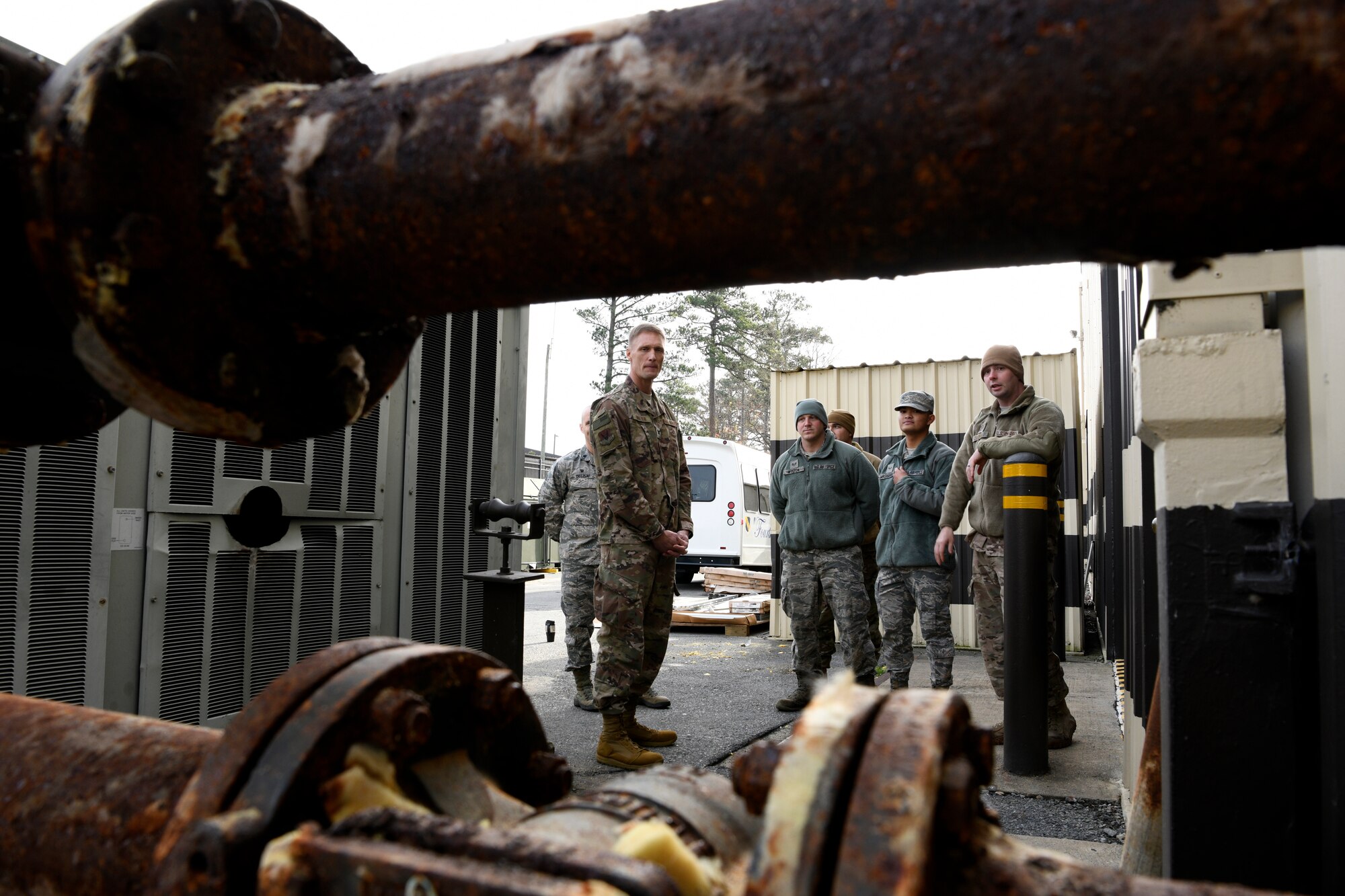 Col. Dee Jay Katzer, Air Combat Command chief of civil engineer division (left), looks at outdated heating, ventilation, and air conditioning pipes Dec. 12, 2018, at Seymour Johnson Air Force Base, North Carolina.