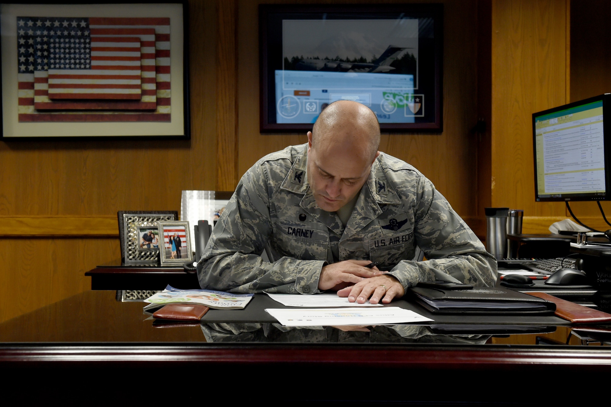 U.S. Air Force Col. Eric Carney, 97th Air Mobility Wing commander, signs paperwork to donate to the Combined Federal Campaign, Dec. 13, 2018, at Altus Air Force Base, Okla. The CFC is an annual campaign that aims to raise money for health and human service charities around the world. (U.S. Air Force Photo by Senior Airman Jackson N. Haddon)