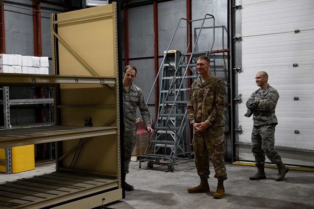 Col. Dee Jay Katzer, Air Combat Command chief of civil engineer division (center), examines a relocated shelving unit Dec. 12, 2018, at Seymour Johnson Air Force Base, North Carolina.