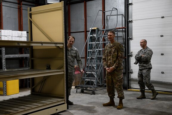 Col. Dee Jay Katzer, Air Combat Command chief of civil engineer division (center), examines a relocated shelving unit Dec. 12, 2018, at Seymour Johnson Air Force Base, North Carolina.