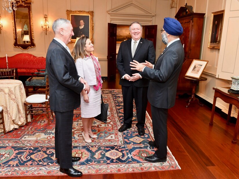 Secretary of State Michael R. Pompeo and Defense Secretary James N. Mattis stand and talk with their Canadian counterparts.