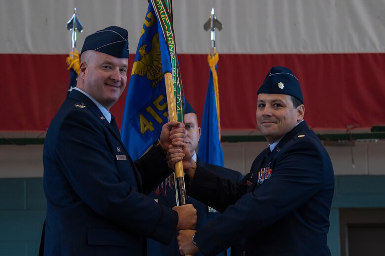 Lt. Col. Joey Sullivan (right) takes the 415th Special Operations Squadron guidon from Col. Richard Carrell, 58th Operations Group commander, during a change of command ceremony here Dec. 14. Col. (U.S. Air Force photo by Airman 1st Class Austin J. Prisbrey)