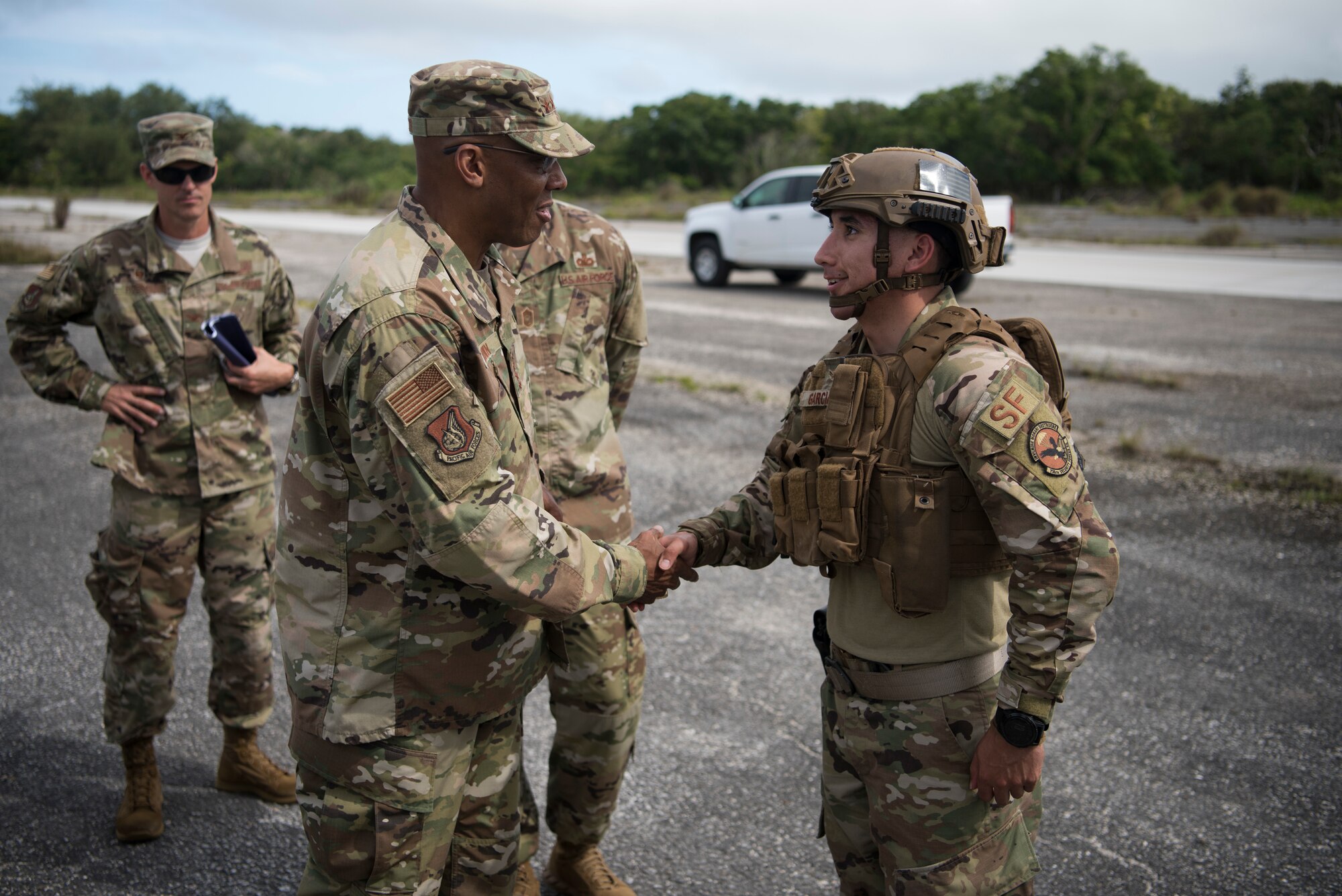 Gen. CQ Brown, Jr., Pacific Air Forces commander, coins Airman 1st Class James Garcia, 736th Security Forces Squadron, during a visit to Andersen Air Force Base, Guam, Dec. 10, 2018. Brown visited with Airmen across the installation and encouraged them to step up and share their innovative ideas as the command works together to be ready, resilient and postured for the future. (U.S. Air Force photo by Senior Airman Zachary Bumpus)