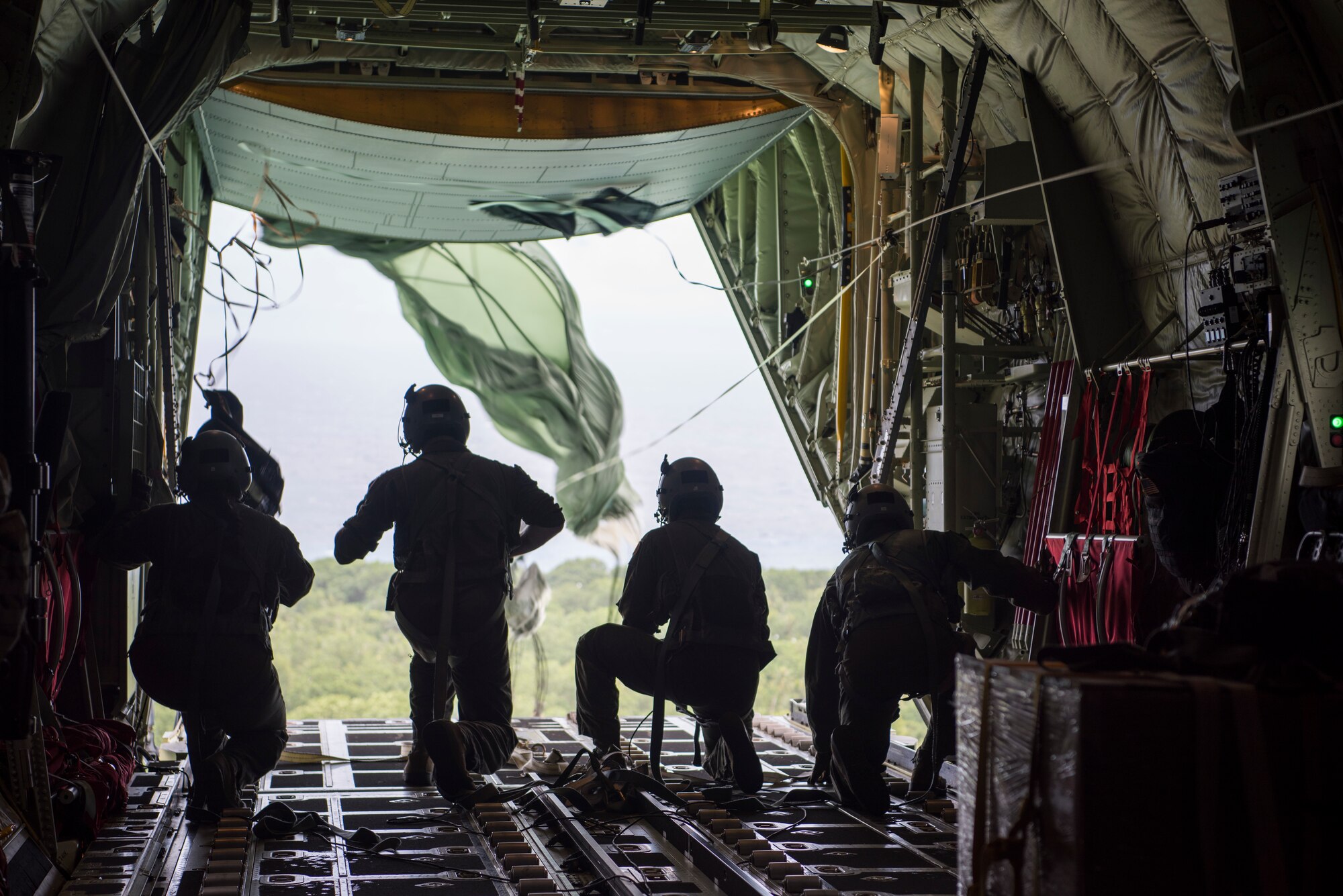 Gen. CQ Brown, Jr., Pacific Air Forces commander, assists a C-130J aircrew, from the 374th Airlift Wing, as they push airdrop bundles from the rear of the aircraft in support of Operation Christmas Drop 2018 Dec. 11, 2018. Brown’s visit to Andersen Air Force Base, Guam, allowed him to familiarize himself with 36th Wing’s mission and role in promoting peace and stability throughout the Indo-Pacific region.(U.S. Air Force photo by Senior Airman Zachary Bumpus)