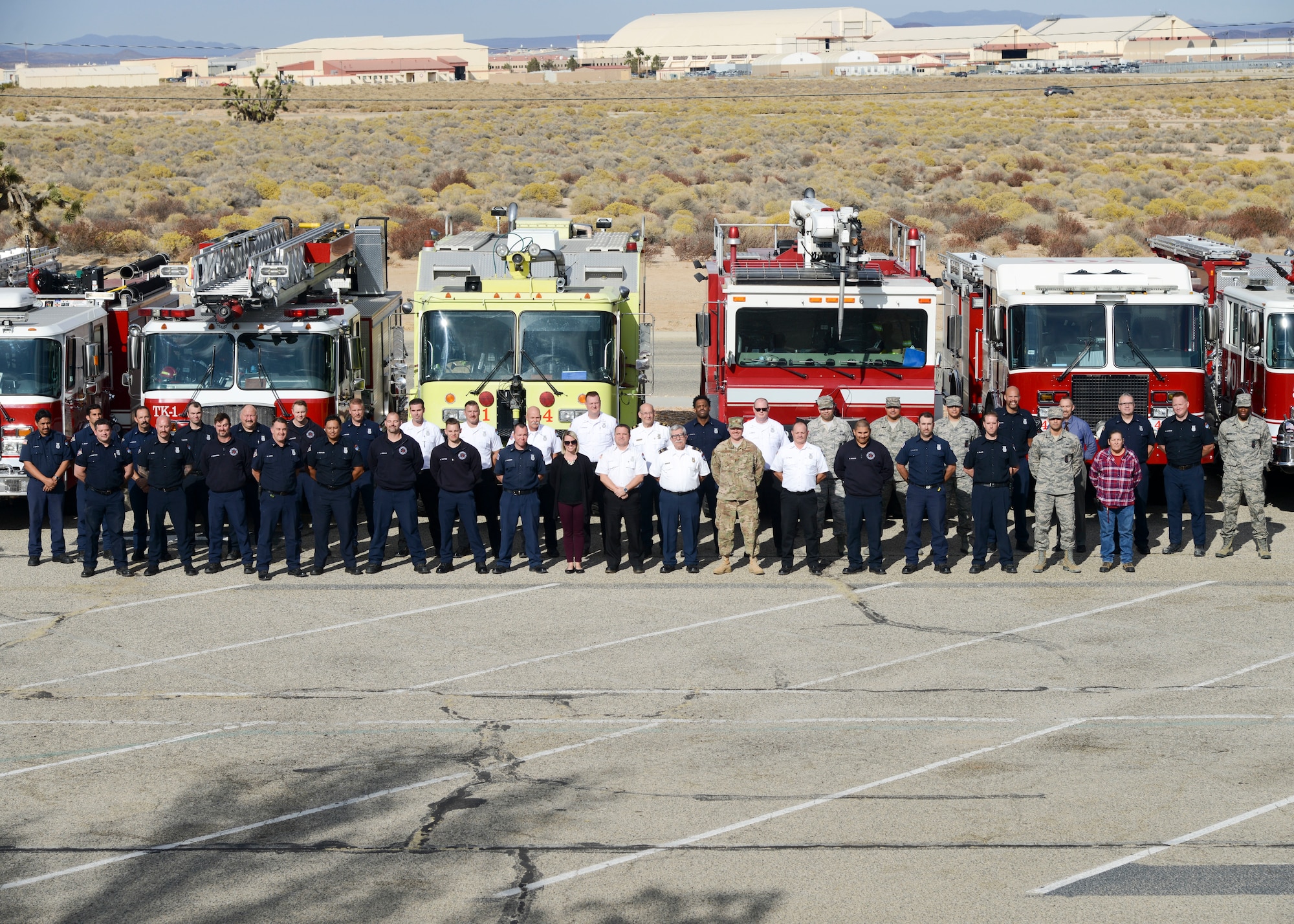 Members of the Edwards Air Force Base Fire and Emergency Services pose for a group photo with retiring Fire Chief, Michael Hurles, at Edwards Air Force Base, California, Nov. 16. (U.S. Air Force photo by Giancarlo Casem)