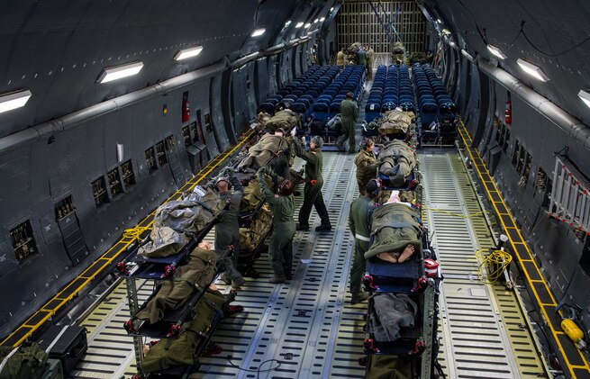 U.S. Air Force aeromedical evacuation team members participate in a training scenerio during a C-5M Super Galaxy AE proof of concept flight from Scott AFB, Illinois, Dec. 5, 2018. Active Duty, Reserve and Delaware Air National Guard Airmen worked together during the PoC to test the cargo compartment of the C-5M with the goal of establishing the aircraft as part of the universal qualification training program for all AE crews. If approved and certified, the C-5M will have the capability to move three times the current capacity in one mission compared to other AE platforms. (U.S. Air Force photo by Joey Swafford)