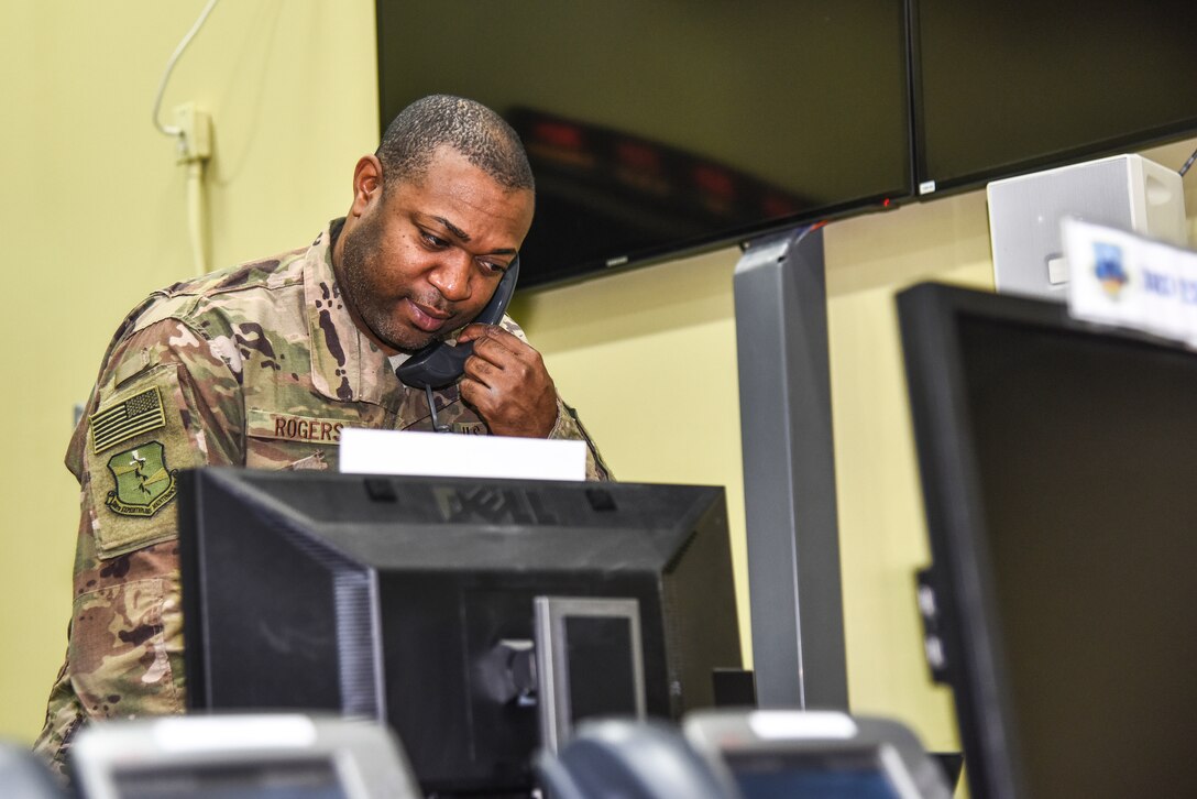 U.S. Air Force Tech. Sgt. Rommel Rogers, 380th Expeditionary Maintenance Group maintenance operations center controller, answer a phone call at Al Dhafra Air Base, United Arab Emirates, Dec. 9, 2018. The MOC communicates information directly to the EMXG commander and disperses it to all maintenance personnel. (U.S. Air Force photo by Senior Airman Mya M. Crosby)