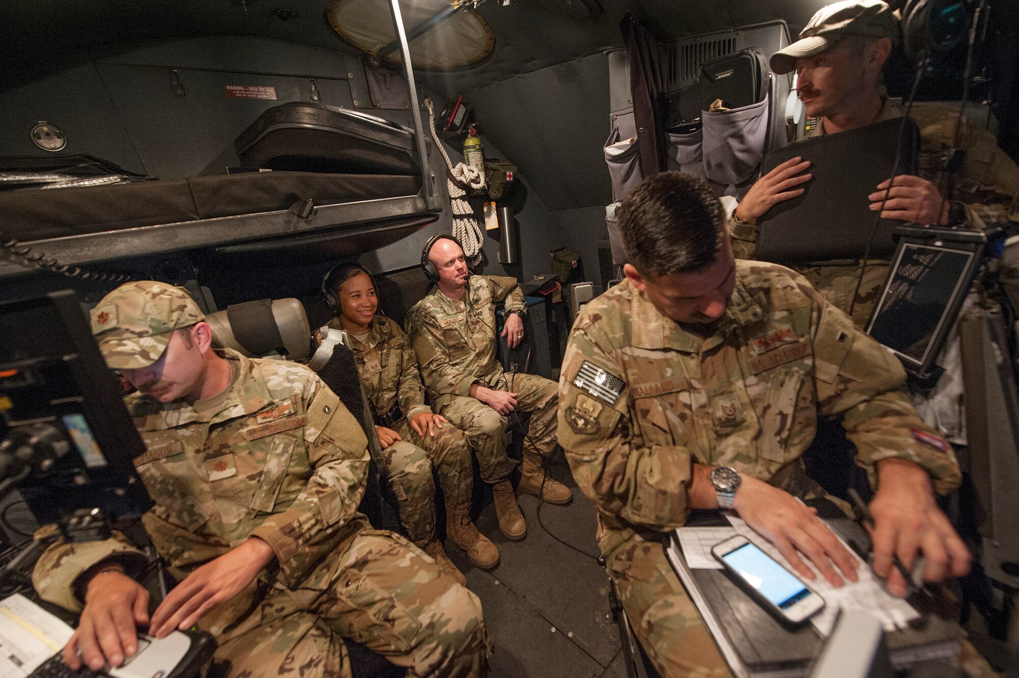 Staff Sgt. Daneasha Jenkins, background left, and Chaplain (Maj.) Cody Hollist, background right, both assigned to the 379th Air Expeditionary Wing (AEW) chapel office, interact with aircrew members of the 746th Expeditionary Airlift Squadron on a C-130 Hercules prior to takeoff Dec. 15, 2018, at Al Udeid Air Base, Qatar.