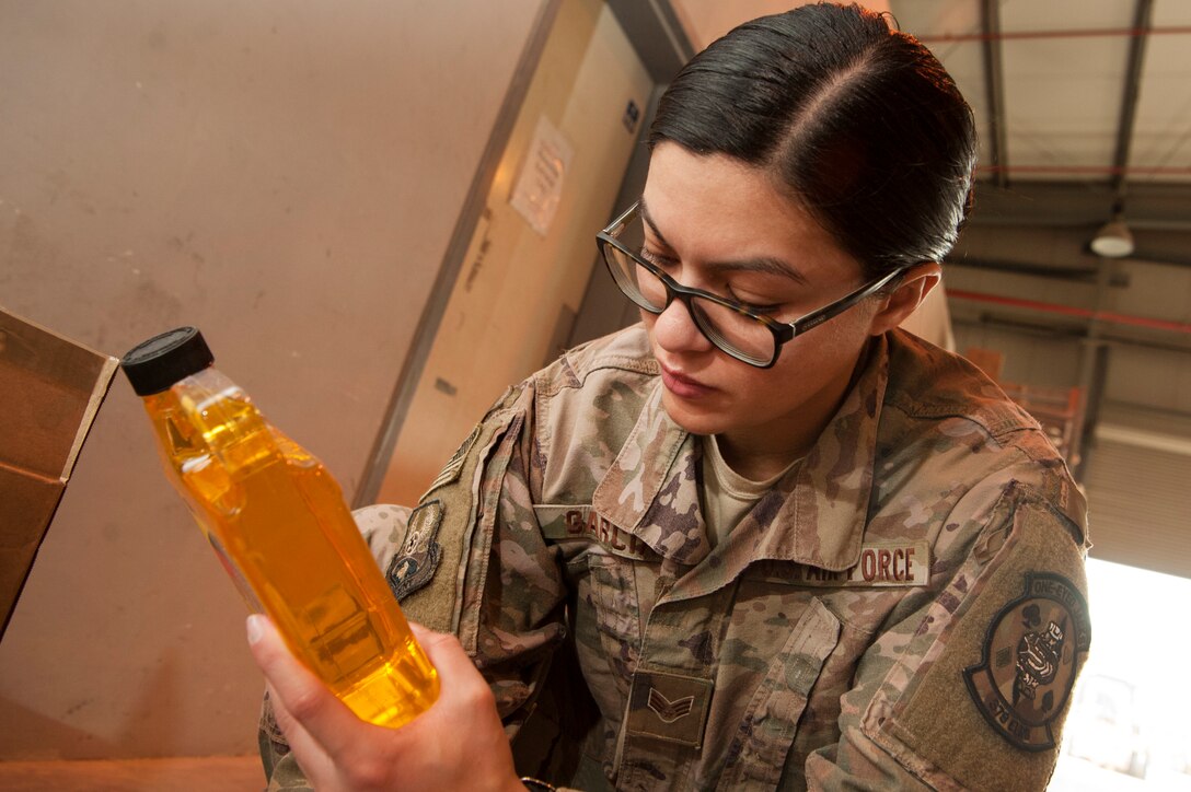 Senior Airman Erica Garcia, 379th Expeditionary Logistics Readiness Squadron hazardous material (HAZMAT) pharmacy technician, picks up hazardous material orders at the Transportation Management Office Dec. 13, 2018, at Al Udeid Air Base, Qatar.
