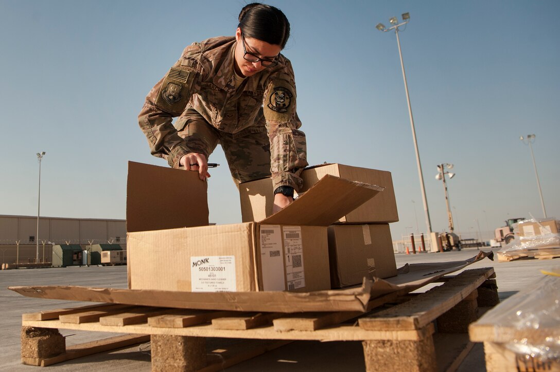 Senior Airman Erica Garcia, 379th Expeditionary Logistics Readiness Squadron hazardous material (HAZMAT) pharmacy technician, picks up hazardous material orders at the Transportation Management Office Dec. 13, 2018, at Al Udeid Air Base, Qatar.