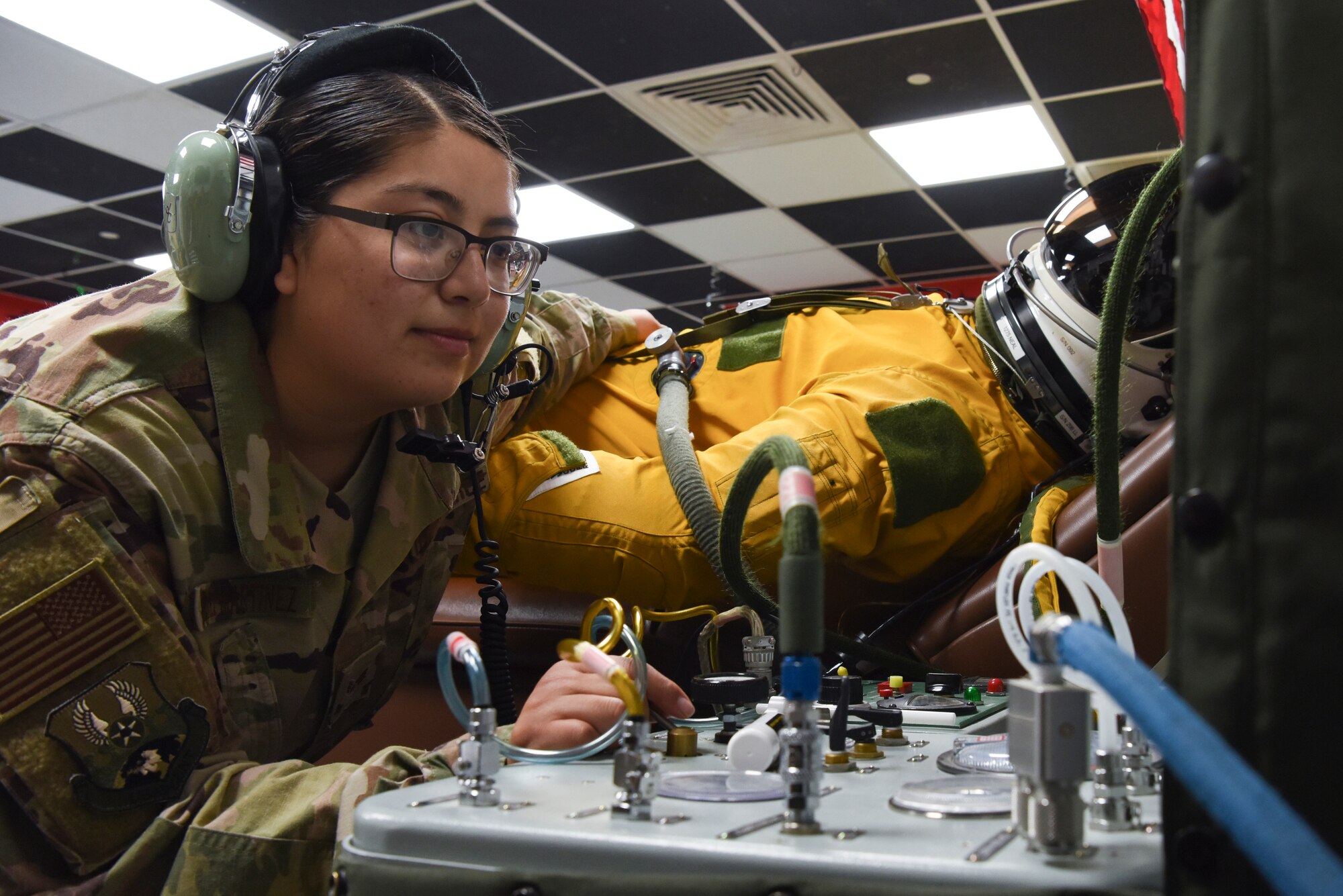 Senior Airman Yomira Ramirez-Martinez, 99th Expeditionary Reconnaissance Squadron aerospace physiology technician, inflates the U-2 pilot’s full-pressure suit at Al Dhafra Air Base, United Arab Emirates, Dec. 12, 2018.