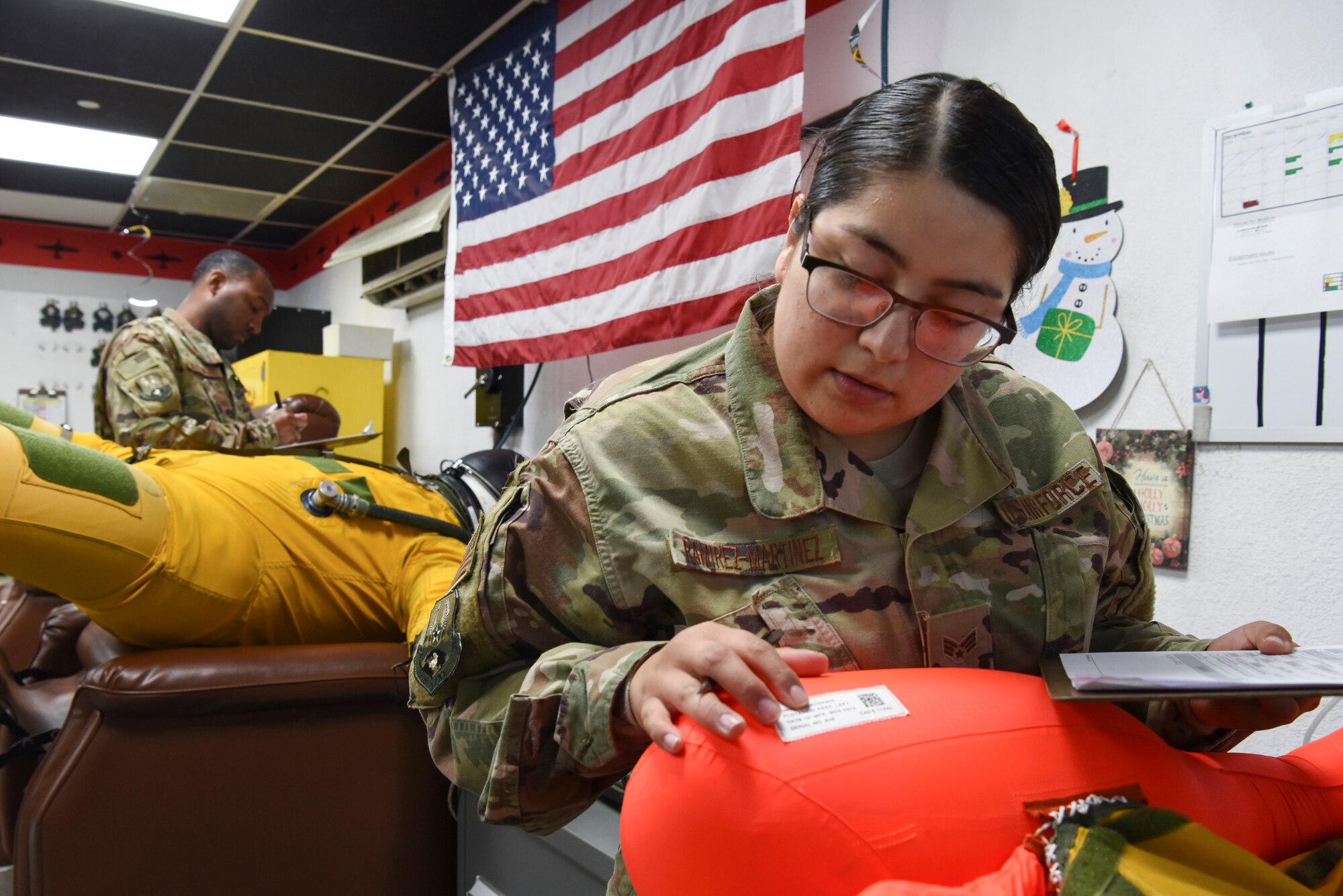 Staff Sgt. William Hazelwood, 99th Expeditionary Reconnaissance Squadron launch and recovery supervisor, inspects the U-2 pilot’s full-pressure suit while Senior Airman Yomira Ramirez-Martinez, 99th ERS aerospace physiology technician, inspects the torso component at Al Dhafra Air Base, United Arab Emirates, Dec. 12, 2018.