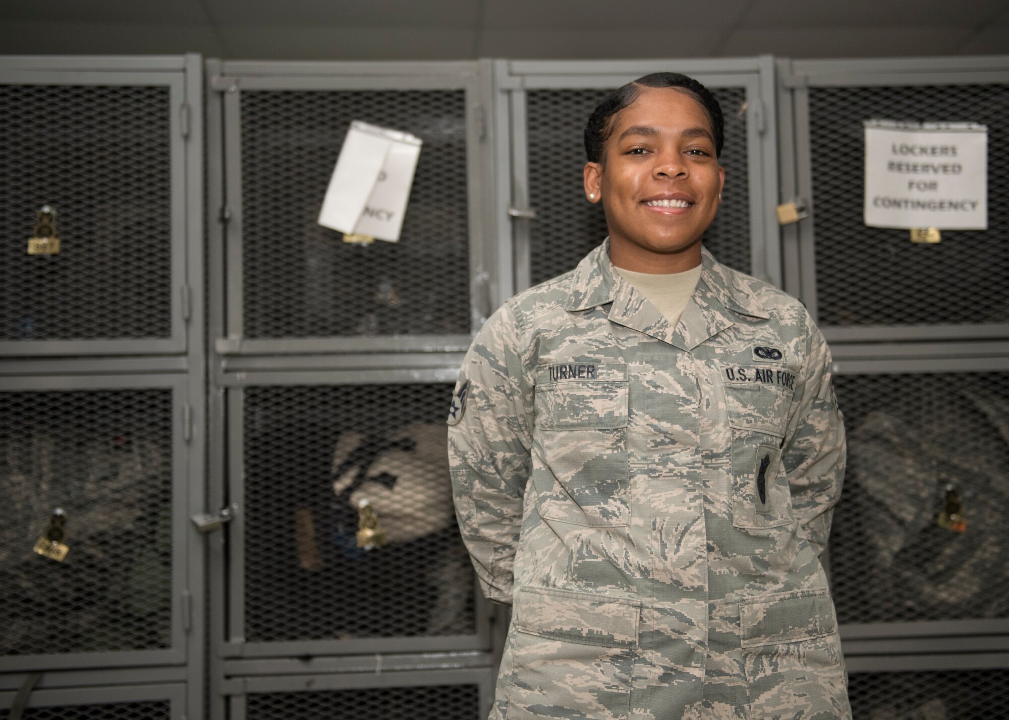 Airman poses for performance recognition photo.