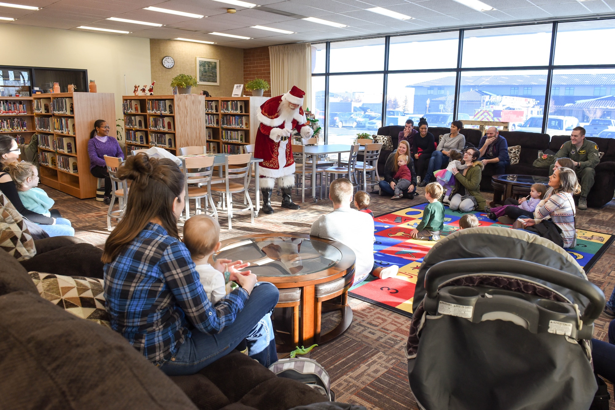 Santa Claus speaks to children at the Holbrook Library on Ellsworth Air Force Base, S.D., Dec. 13, 2018. Just 12 days prior his adventures on Christmas Eve, Santa took the time to spread holiday cheer with the children of Ellsworth AFB. (U.S. Air Force photo by Airman John Ennis)