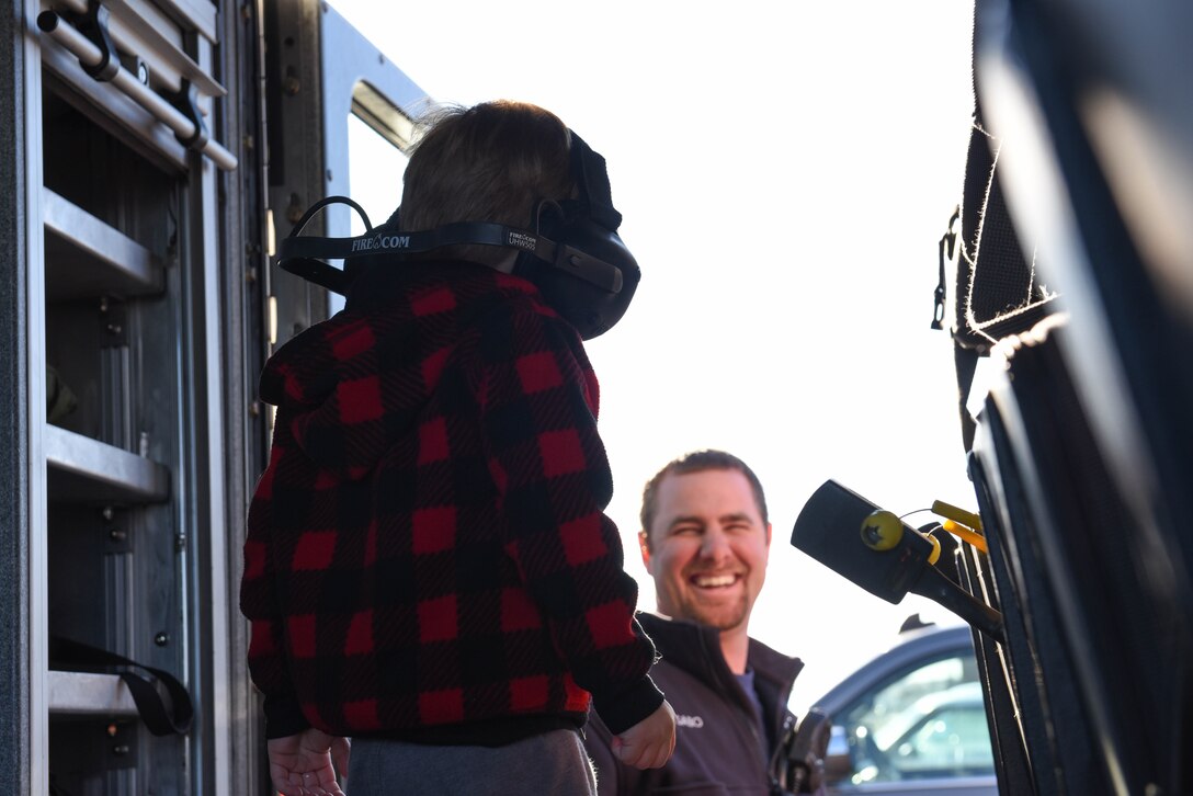 A child is shown the different components of a fire truck on Ellsworth Air Force Base, S.D., Dec. 13, 2018. Following a “Santa and Me Story Time” event at the Holbrook Library, attendees were invited to the parking lot to tour a fire truck and visit with firefighters from the 28th Civil Engineer Squadron Fire Department. (U.S. Air Force photo by Airman John Ennis)