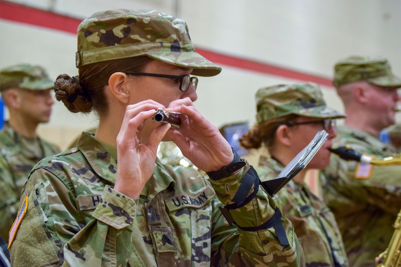 U.S. Army Reserve Sgt. Natalie Harper, a senior musician with the 78th Army Band, plays the piccolo, during the 99th Readiness Division change of command ceremony, Dec. 16 at Doughboy Gym, on Joint Base McGuire-Dix-Lakehurst, New Jersey. The 99th DIV(R) is headquartered on JBMDL, which is the second-largest employer in New Jersey, second only to the state government. More than 40,000 active-duty and reserve-component service members, civilian employees and family members work and reside on the base.