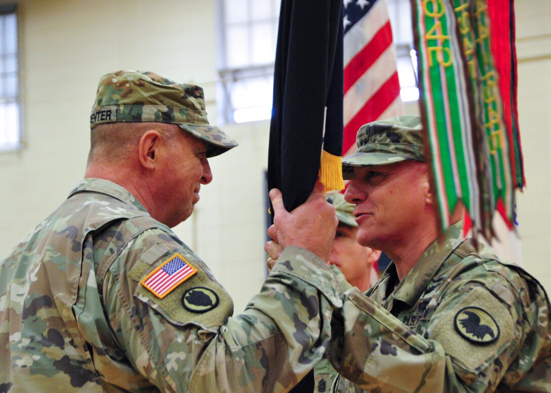 Maj. Gen. Troy D. Kok, outgoing commander, passes the colors to Maj. Gen. Scottie Carpenter, the Deputy Commanding General of U.S. Army Reserve Command, during the 99th Readiness Division change of command ceremony, Dec. 16 at Doughboy Gym, on Joint Base McGuire-Dix-Lakehurst, New Jersey. Kok has been chosen to command the U.S. Army Reserve Accessions Task Force with the mission of helping the Army Reserve meet its end-strength personnel goals in order to remain the most capable, combat-ready and lethal federal reserve force in the nation’s history. This new task force will be headquartered at Fort Knox, Kentucky.