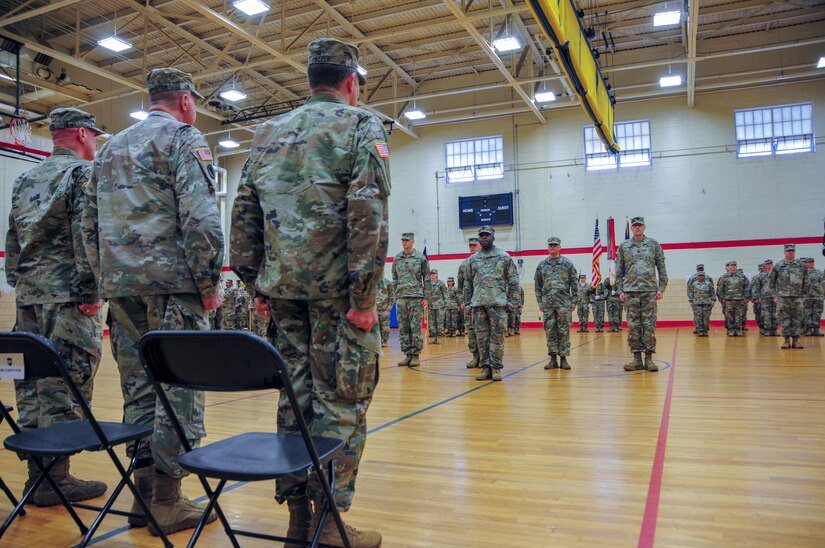 From right to left) Maj. Gen. Mark W. Palzer, the incoming commanding general,  Maj. Gen. Scottie Carpenter, the Deputy Commanding General of U.S. Army Reserve Command, and  Maj. Gen. Troy D. Kok, the outgoing commanding general stand at attention during the 99th Readiness Division change of command ceremony, Dec. 16 at Doughboy Gym, on Joint Base McGuire-Dix-Lakehurst, New Jersey. Both Kok and Palzer are New Jersey natives, the former having grown up in the Allentown area and the latter a current resident of Jackson.