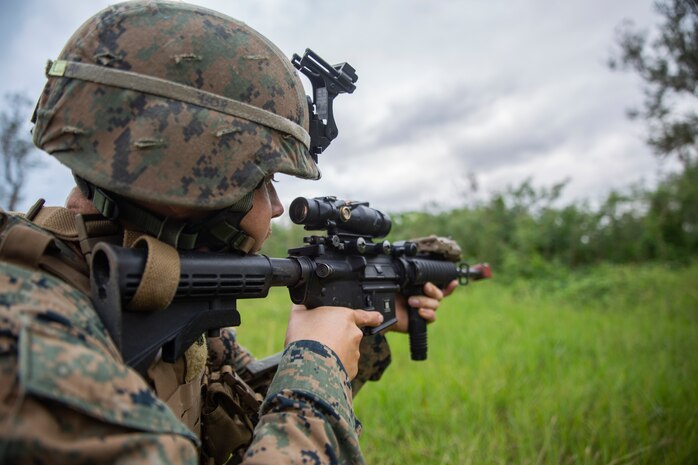 Cpl. Bo J. Bloom provides security at Kin Blue Training Area, Okinawa, Japan on Dec. 12, 2018 during 3rd Marine Logistics Group's Command Post Exercise 19.1. The purpose of MLG CPX 19.1 is to train 3rd MLG's command element, enhance the unit's warfighting capabilities and to assist the commanding general with maintaining situational awareness while making timely decisions. Bloom, a native of Thousand Oaks, California, is an assistant platoon sergeant with Jump Platoon, Headquarters Company, Combat Logistics Regiment 37. (U.S. Marine Corps photo by Lance Cpl. Terry Wong)