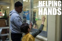 Lance Cpl. Derek S. Pulu helps a student clean a window Dec. 14, 2018 at Ginowan City, Okinawa, Japan. Marines and Sailors with Combat Logistics Battalion 4, Combat Logistics Regiment 3, 3rd Marine Logistics Group, volunteered at the AmerAsian School in Okinawa to help with various beautification projects around the school. The school conducts triannual clean-up projects before each semester. Pulu, a native of American Samoa, is a motor transportation operator with Transportation Service Company, CLB-4, CLR-3, 3rd MLG. (U.S. Marine Corps photo by Lance Cpl. Armando Elizalde)