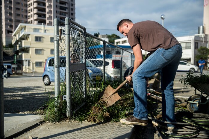Lance Cpl. Dylan L. Simpson shovels weeds from a flower bed Dec. 14, 2018 at Ginowan City, Okinawa, Japan. Marines and Sailors with Combat Logistics Battalion 4, Combat Logistics Regiment 3, 3rd Marine Logistics Group, volunteered at the AmerAsian School in Okinawa to help with various beautification projects around the school. The school conducts triannual clean-up projects before each semester. Simpson, a native of Winston-Salem, North Carolina, is a landing support specialist with Transportation Service Company, CLB-4, CLR-3, 3rd MLG. (U.S. Marine Corps photo by Lance Cpl. Armando Elizalde)