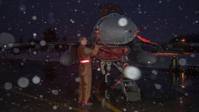 U.S. Air Force Airman 1st Class Avery Fortenbery, a 13th Aircraft Maintenance Unit crew chief, installs a pitot probe protective cover on an F-16 Fighting Falcon at Misawa Air Base, Japan, Dec. 11, 2018. Airmen ensure the mission goes on, no matter the weather. (U.S. Air Force photo by Airman 1st Class Genesis Tejada)