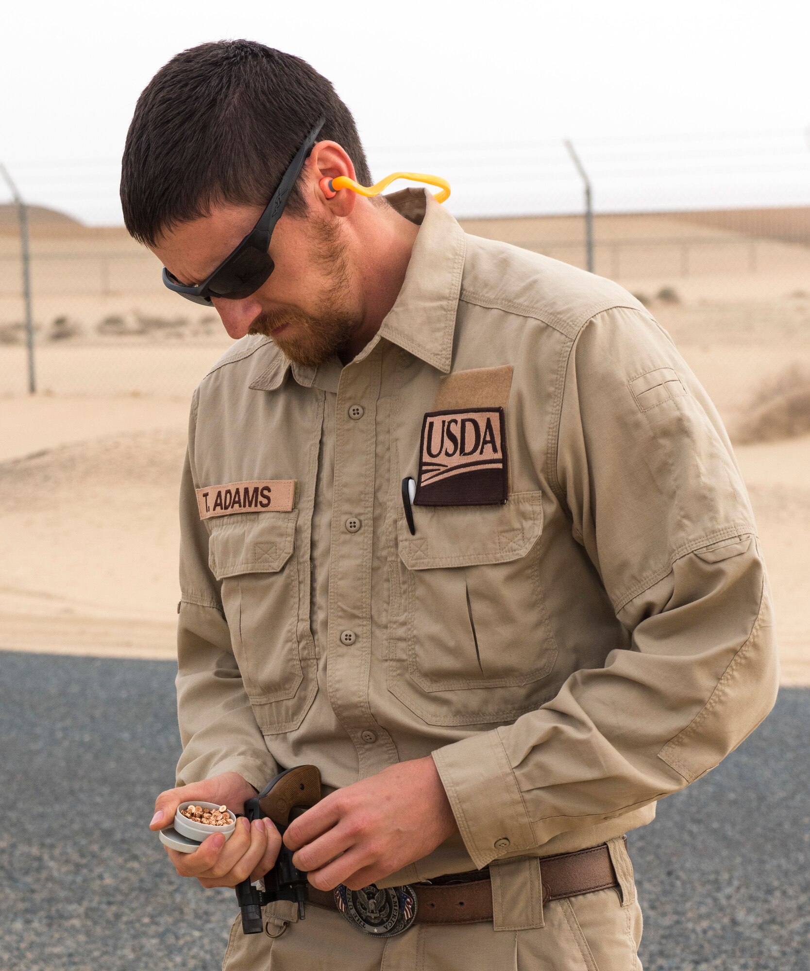 Tyler Adams, United States Department of Agriculture wildlife biologist, loads a revolver with pyrotecnic rounds, used to scare birds out of the area, at an undisclosed location in Southwest Asia, Dec. 3, 2018. During the first ever Bird/wildlife Aircraft Strike Hazard program, airfield managers were trained on not only pyrotecnics, but how to create a continuity binder with wildlife information from the area.