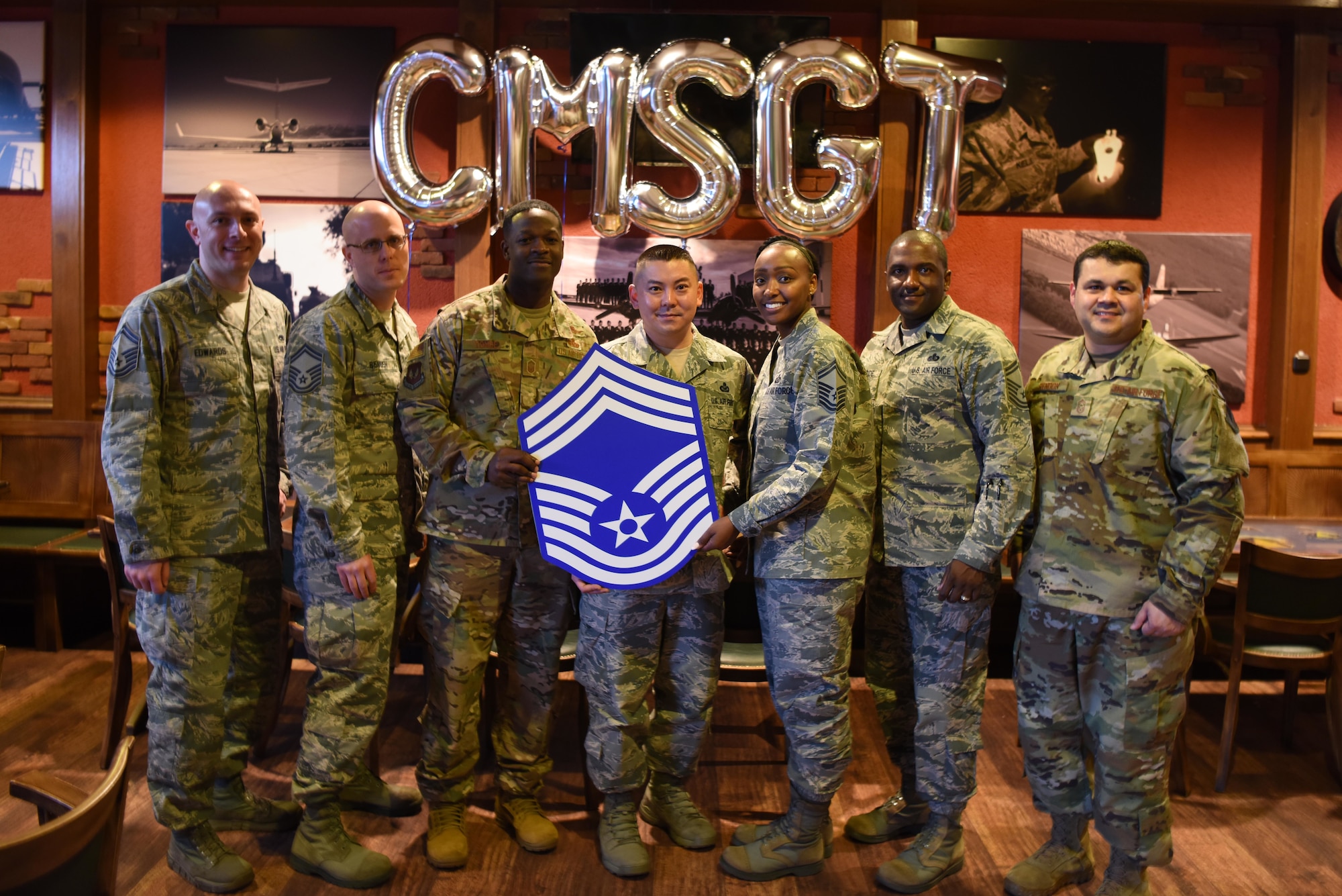 Six of the seven U.S. Air Force Chief Master Sergeant Selects pose for a photo with U.S. Air Force Chief Master Sgt. Ernesto Rendon, 86th Airlift Wing command chief master sergeant on Ramstein Air Base, Germany, Dec. 4, 2018. The six selectees come from various Air Force Specialty Codes and now share a rank that only one percent of all Air Force enlisted members hold.