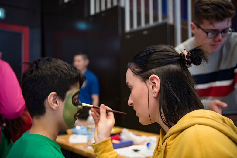 U.S. Air Force Airman 1st Class Emily Szpak, 86th Maintenance Squadron Aerospace Ground Equipment apprentice, puts face-paint on a participant in the Kaiserslautern Military Community Special Olympics Winter Event, Dec. 7, 2018 at the Polizei Academy in Enkenbach-Alsenborn, Germany. During the event, each athlete was paired with one of approximately 100 KMC volunteers. These volunteers gave their buddies tips and tricks during each event the athlete participated in. (U.S. Air Force photo by Airman 1st Class Kristof J. Rixmann)