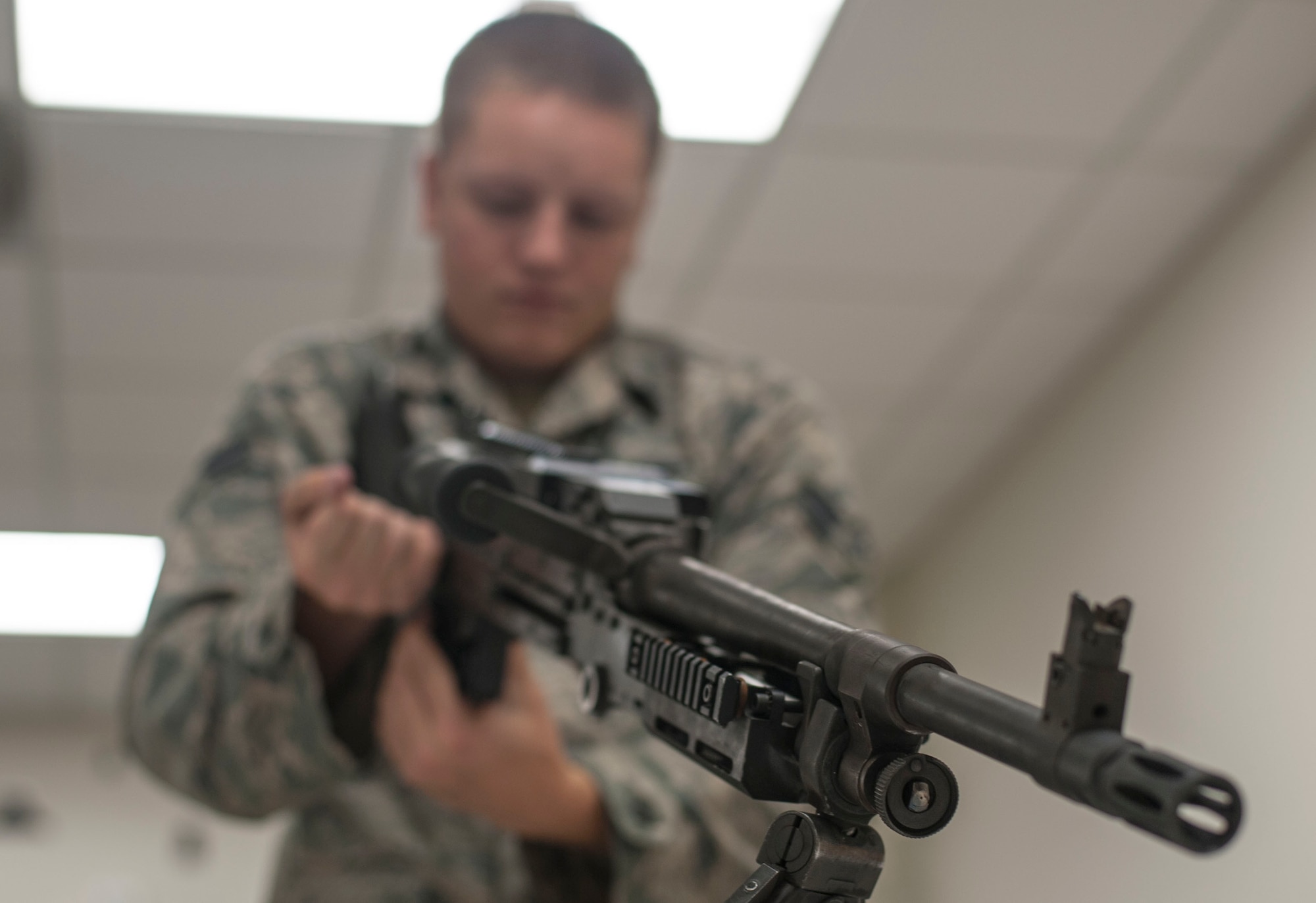U.S. Air Force Senior Airman Christian Britton, a 6th Security Forces Squadron (SFS) marine patrolman, charges the bolt of an M240 machine gun during combat arms heavy weapons training at MacDill Air Force Base, Fla., Dec. 10, 2018.