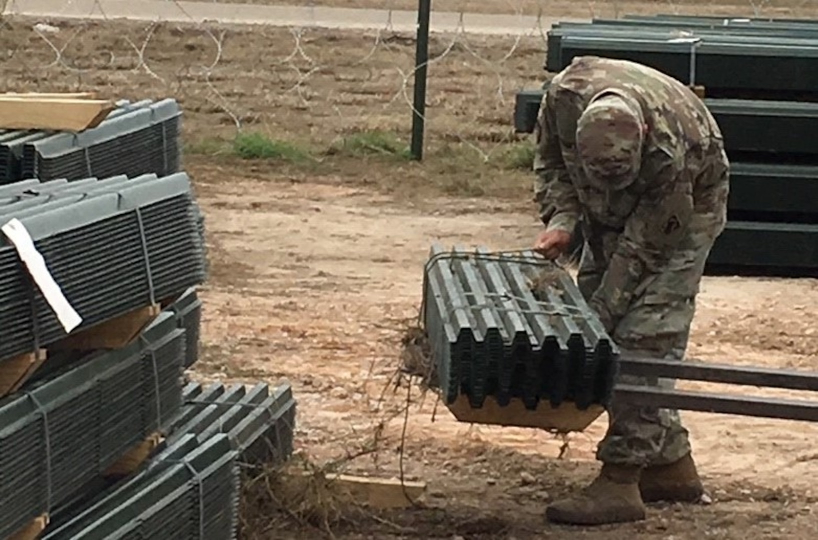 Soldier unloading construction material