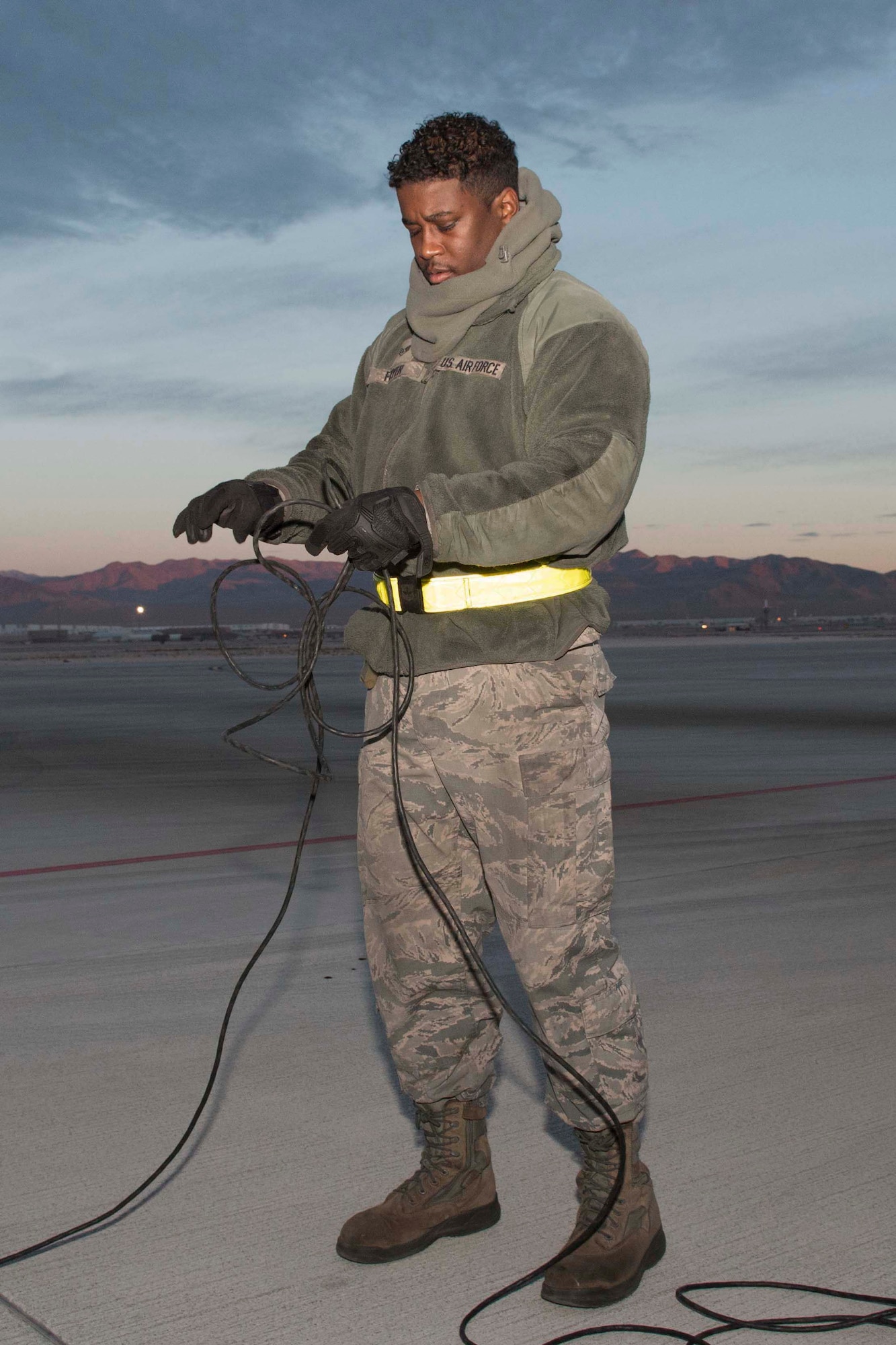 U.S. Air Force Staff Sgt. Jamall Fryer, 11th Aircraft Maintenance Unit crew chief, prepares for an early morning sortie at Nellis Air Force Base, Nevada, Dec. 11, 2018.  Fryer, an active-duty Airman, served alongside Reserve Citizen Airman during the biannual Weapons School Integration exercise.  The two components regularly work together as part of the total force integration model. (U.S. Air Force photo by Master Sgt. Ted Daigle)