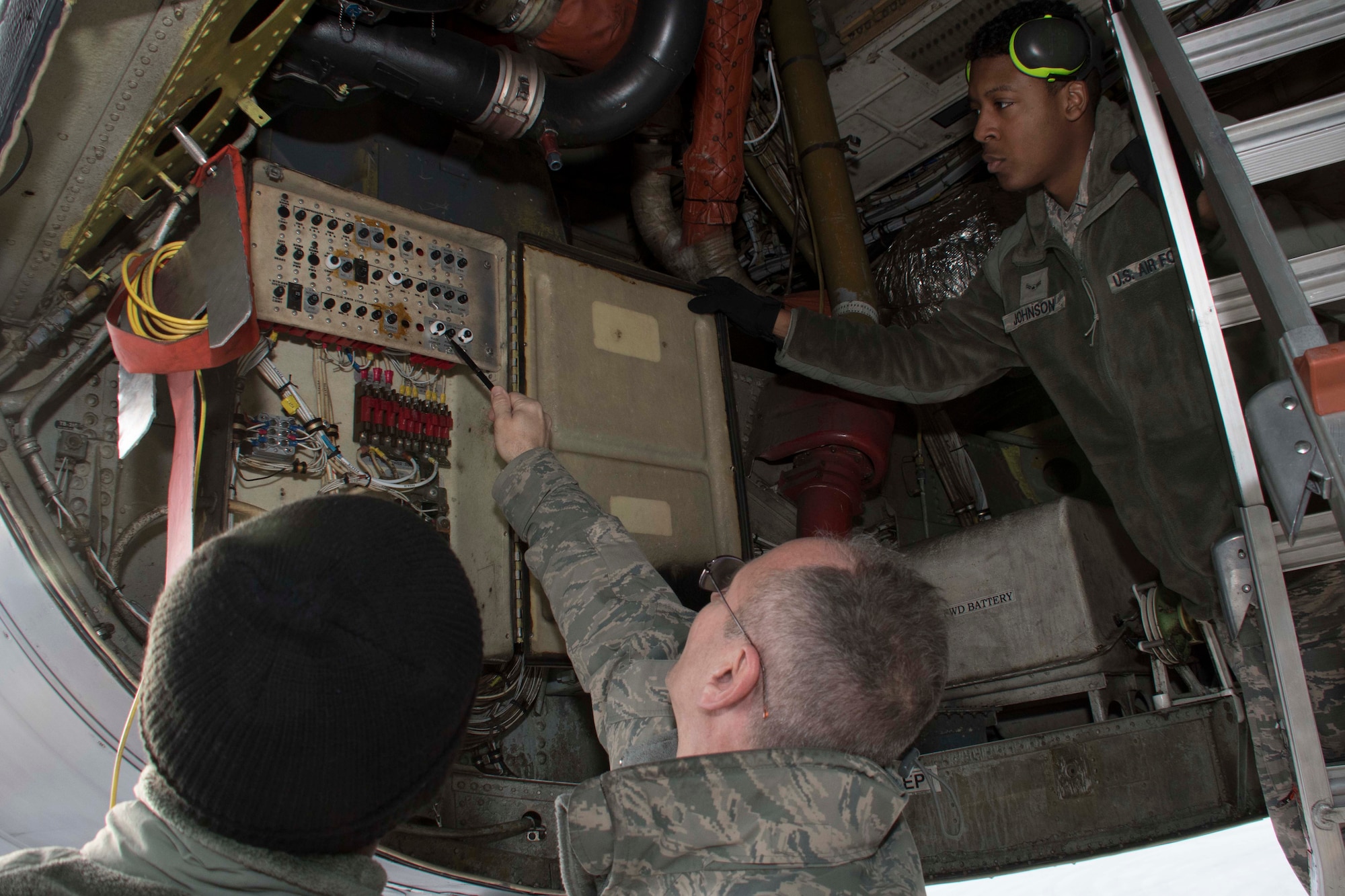 U.S. Air Force Master Sgt. Tim Pastore, 307th Aircraft Maintenance Squadron avionics specialist, reviews work done on a B-52 Stratofortress breaker box done by Senior Airman Deonitis Gardiner and Airman First Class James Johnson, 11th Aircraft Maintenance Unit journeymen, at Nellis Air Force Base, Nevada, Dec. 11, 2018.   Pastore is a Reserve Citizen Airman.  He regularly mentors active-duty Airmen like Gardiner and Johnson in keeping with the total force integration model. (U.S. Air Force photo by Master Sgt. Ted Daigle)