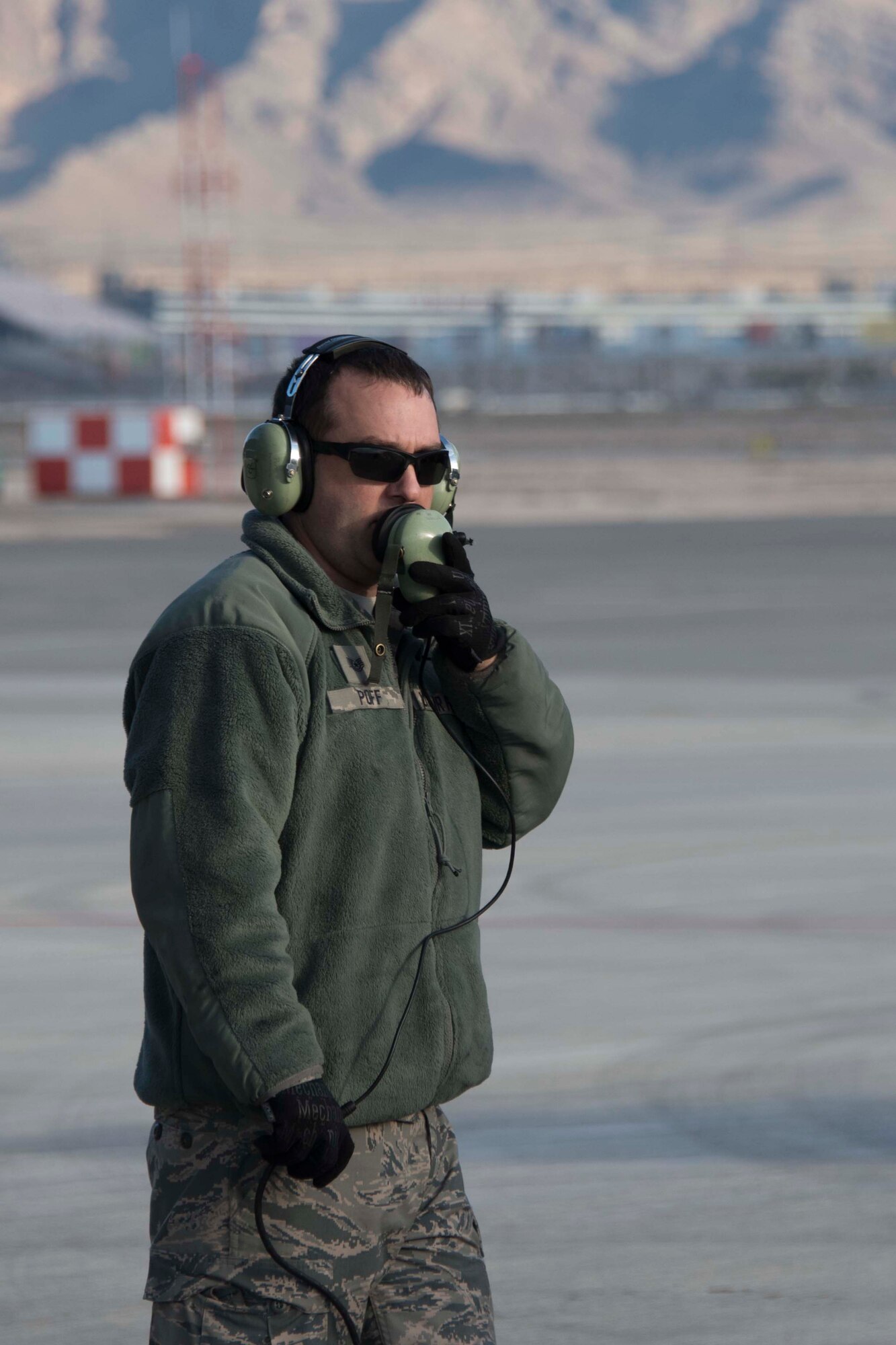 U.S. Air Force Tech. Sgt. Rick Poff, 307th Aircraft Maintenance Squadron crew chief, communicates with B-52 Stratofortress air crew prior to a sortie, Dec. 11, 2018 at Nellis Air Force Base, Nevada.  He was on hand, along with other active-duty and Reserve Citizen Airmen maintainers, to support the the biannual Weapons School Integration exercise. (U.S. Air Force photo by Master Sgt. Ted Daigle)