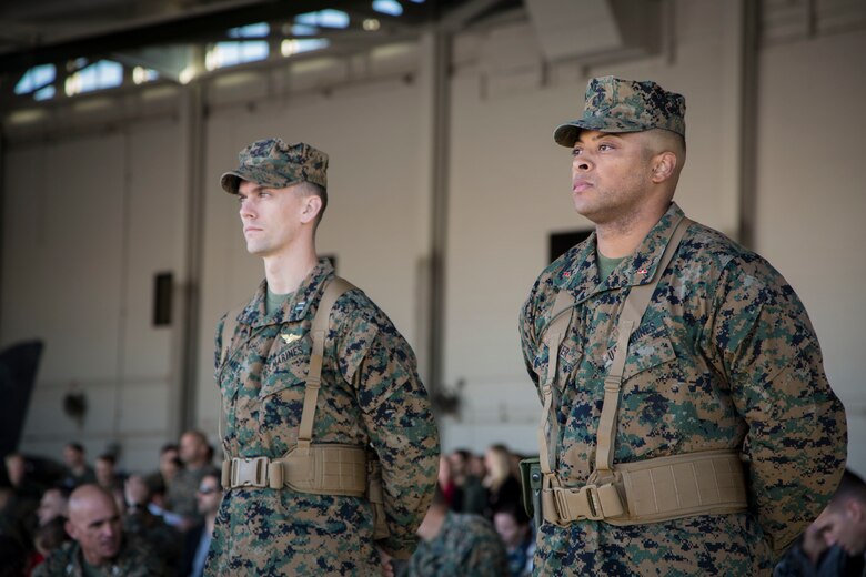 U.S. Marine Corps Capt. Samuel Mahaney (left) and WO Breeland Gloster (right) with Marine Attack Squadron 311 (VMA-311), Marine Corps Air Station (MCAS) Yuma, participate in the Change of Command Ceremony where Lt. Col. Michael W. McKenney, commanding officer for VMA-311 relinquished command to Lt. Col. Robb T. McDonald on MCAS Yuma, Ariz., Dec. 13, 2018. The Change of Command Ceremony represents the transfer of responsibility, authority, and accountability from the outgoing commanding officer to the incoming commanding officer. (U.S. Marine Corps photo by Sgt. Allison Lotz)