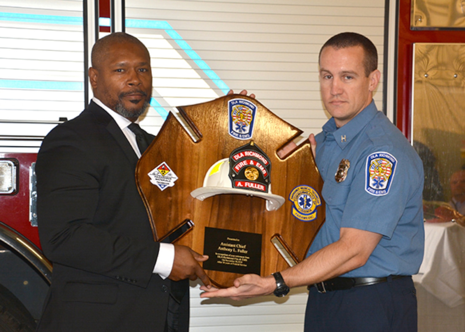 Assistant Fire Chief Fuller receives plaque at his retirement ceremony